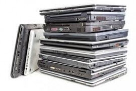 pile of broken laptops for cash